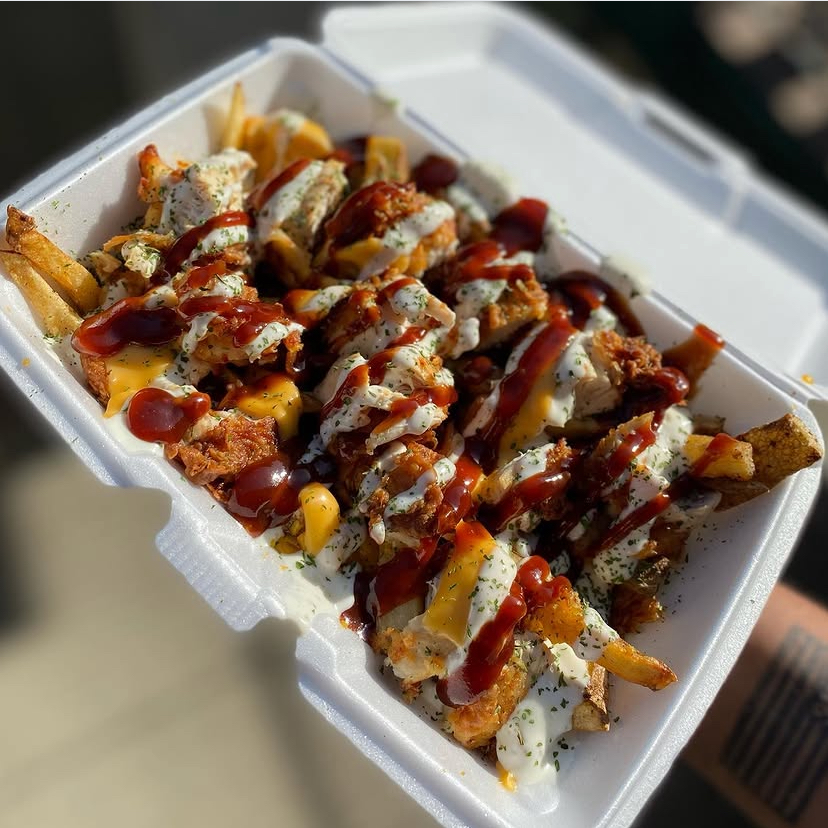 Loaded fries piled with chicken, cheese sauce, ranch and BBQ