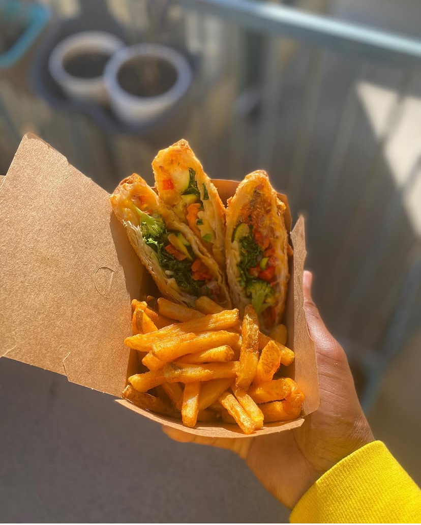 Veggie eggrolls with broccoli and peppers served with seasoned fries