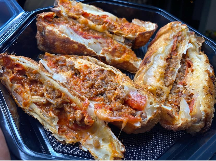 Sliced pizza eggrolls loaded with beef, pepperoni and melted cheese